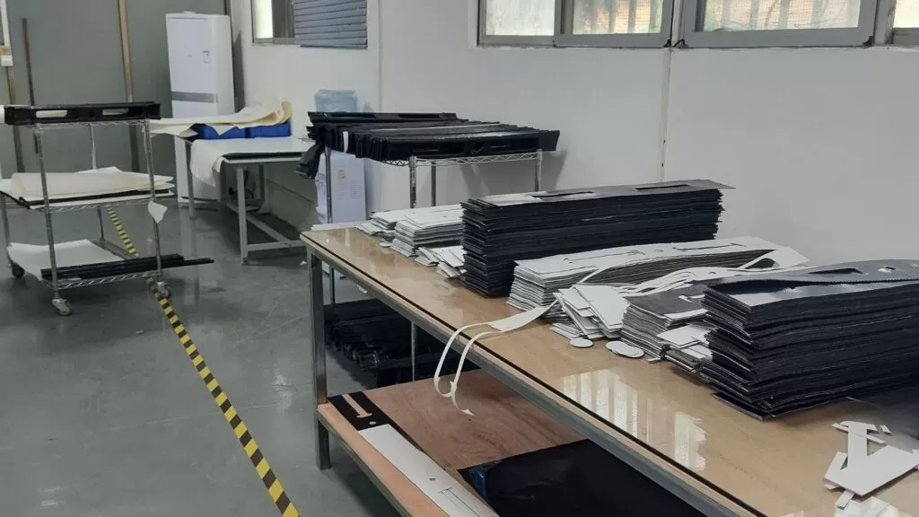 Existing workshop photograph of reinforcement material on a cutting table